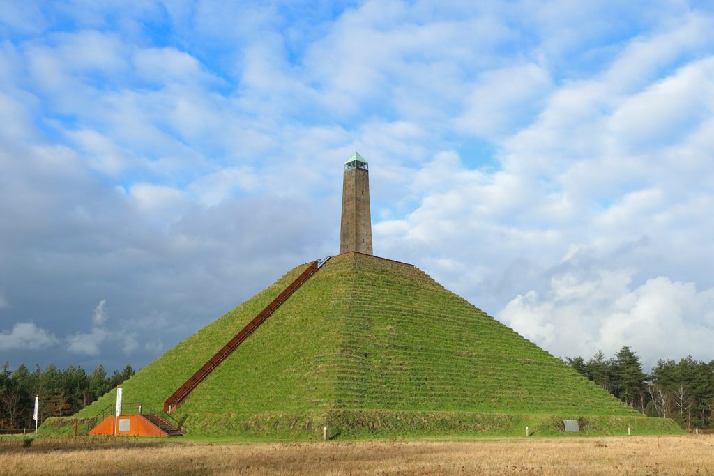 a very tall pyramid with a clock on top of it pyramide van Austerlitz