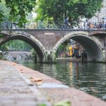brown concrete bridge over river during daytime